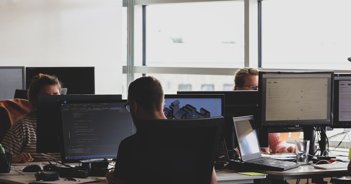 Split screen showing AI coding tools generating application code from natural language prompts — vibe coding tools comparison