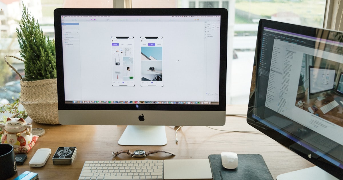 Clean workspace with iMac showing website design, representing the Webflow vs Squarespace decision for businesses