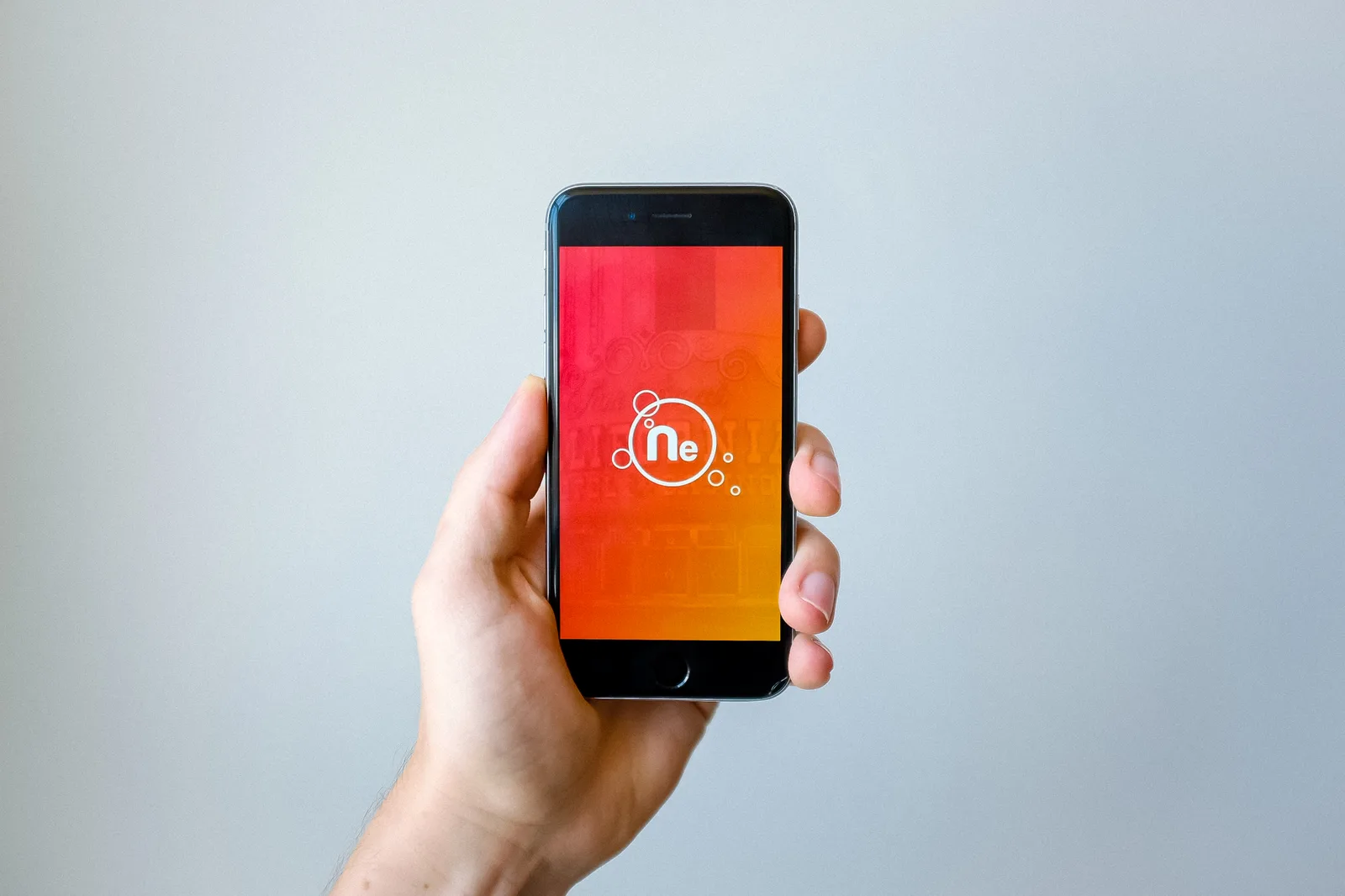 A hand holding a smartphone, the way a customer searches for a local business